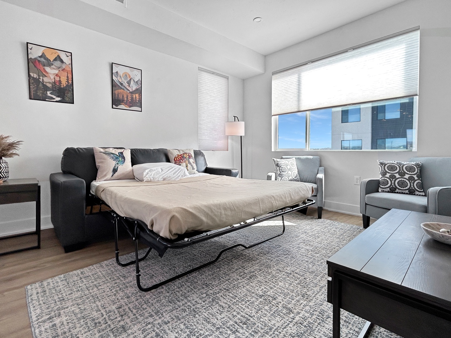 Unwind in your spacious living room where the sofa transforms into a comfortable bed, perfect for relaxing after exploring the city.