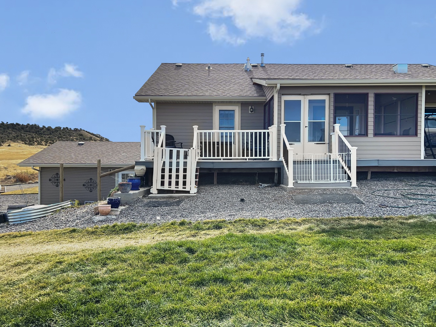 Patio and stairs leading to fenced yard