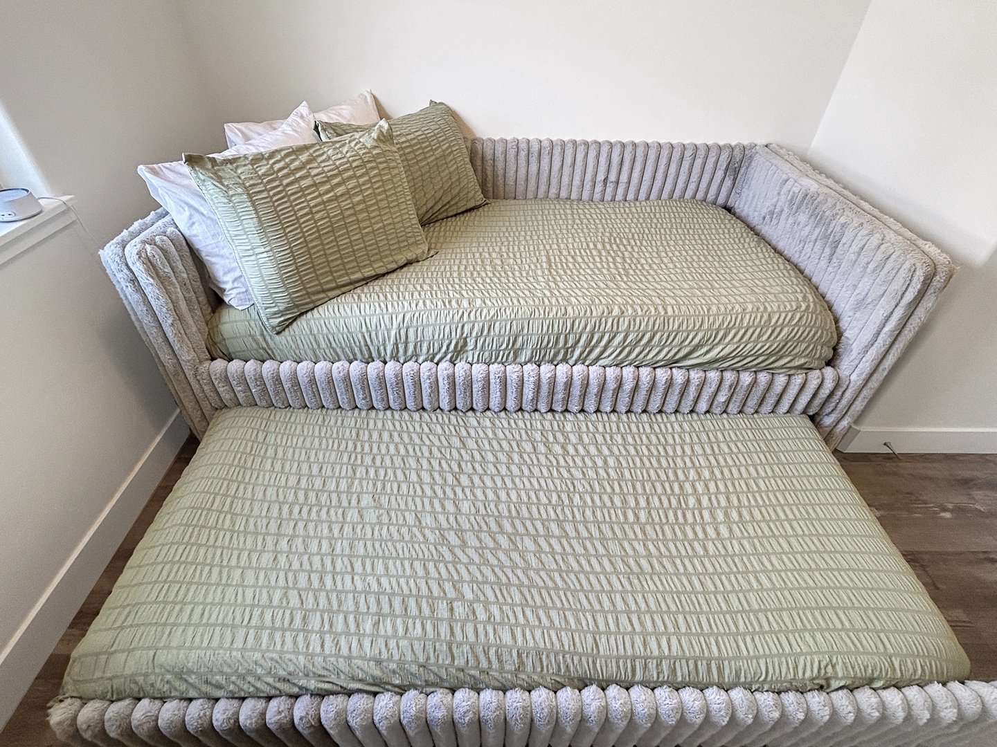 Unwind on this elegant daybed with plush textures and matching pillows, perfect for afternoon naps or cozy reading sessions.