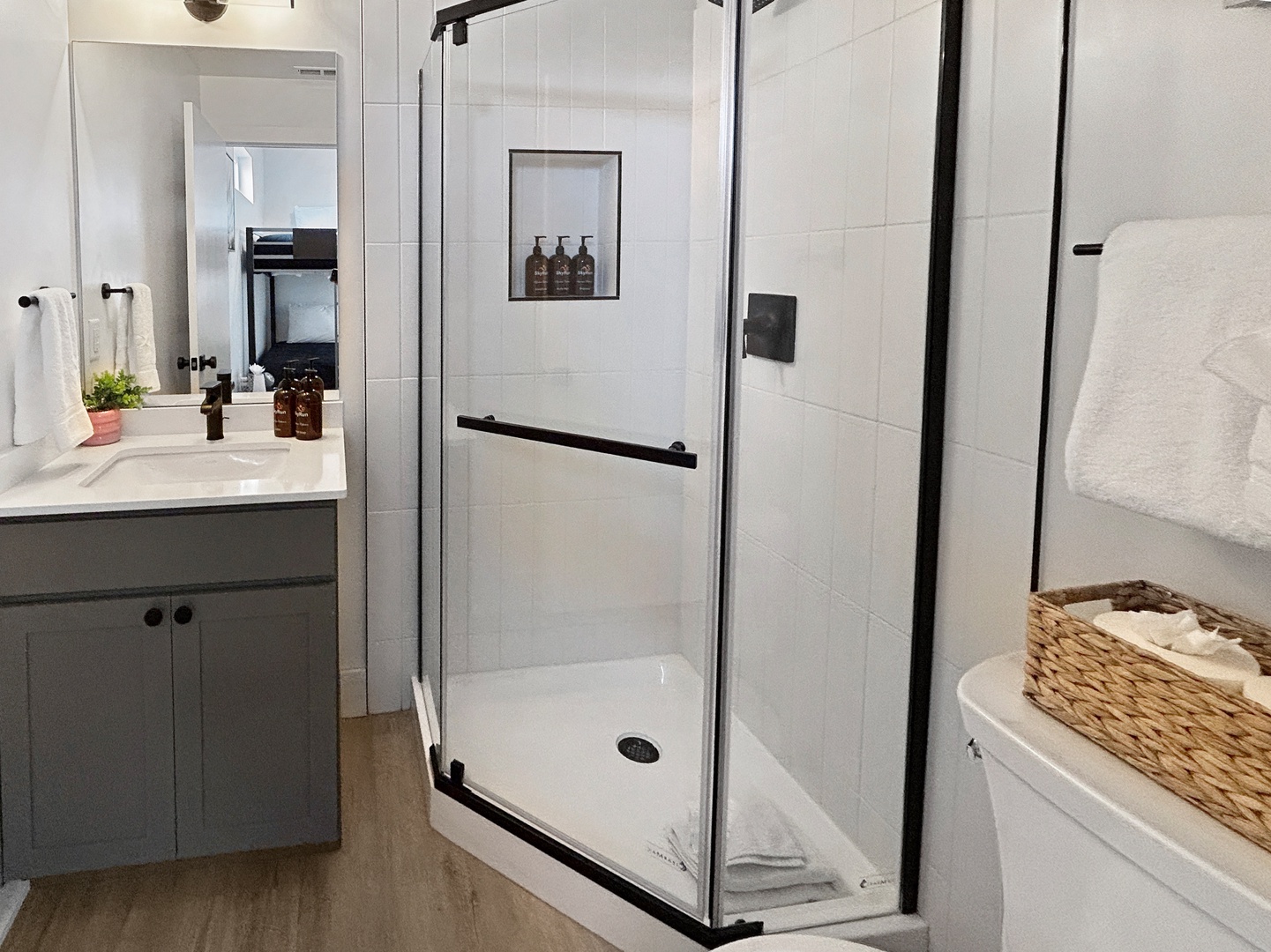 Step into your spa-like bathroom featuring a pristine walk-in shower with sleek glass doors and modern fixtures for your ultimate comfort.