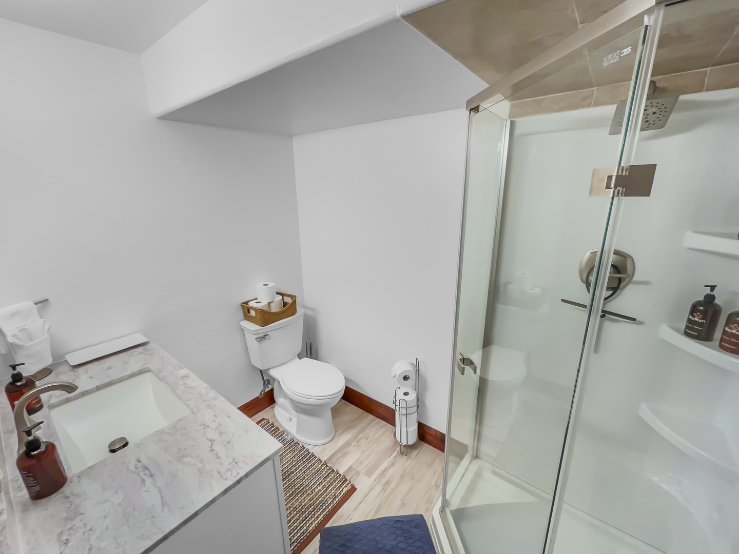 A modern bathroom with a glass-enclosed shower