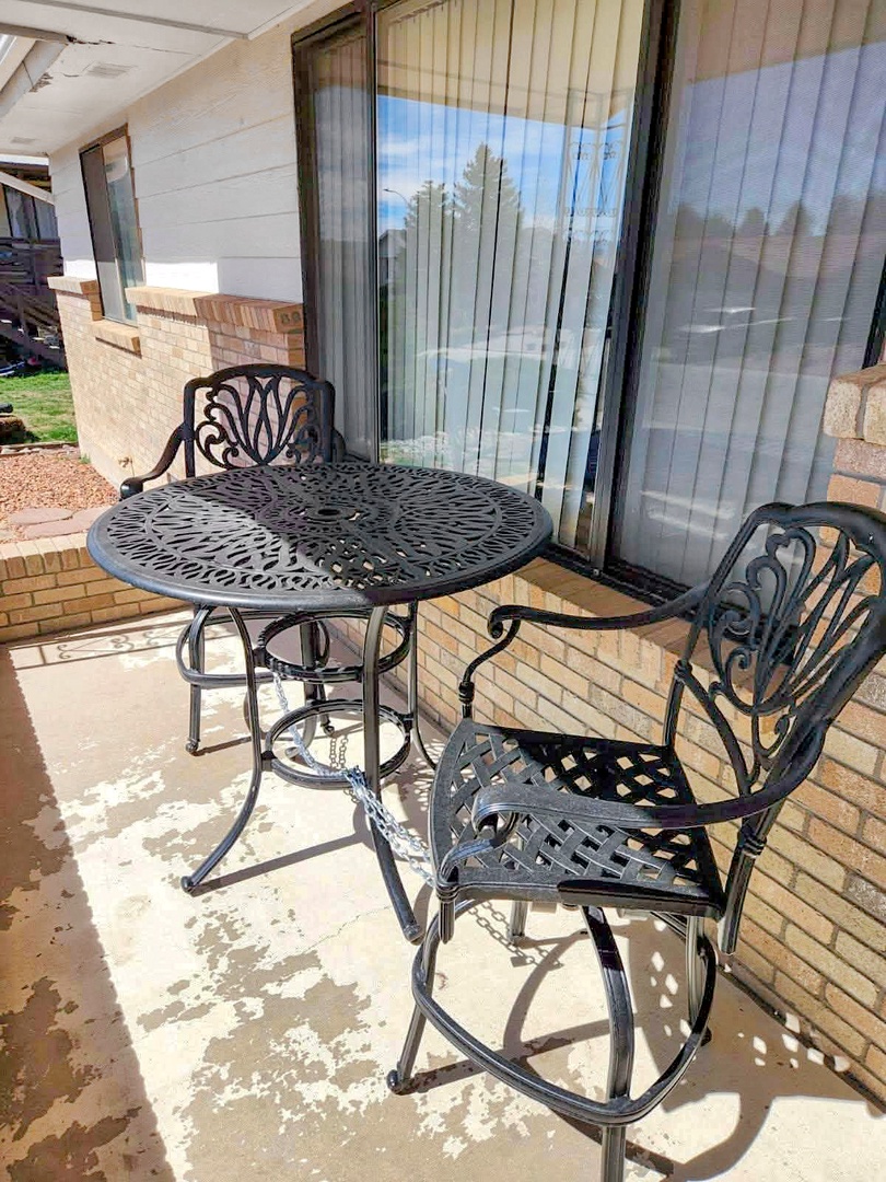 Relax on your private patio with ornate metal furniture, perfect for morning coffee or evening conversations under the sun.