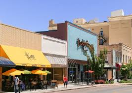 Historic downtown district featuring charming brick storefronts and tree-lined streets perfect for evening strolls and local shopping exploration.