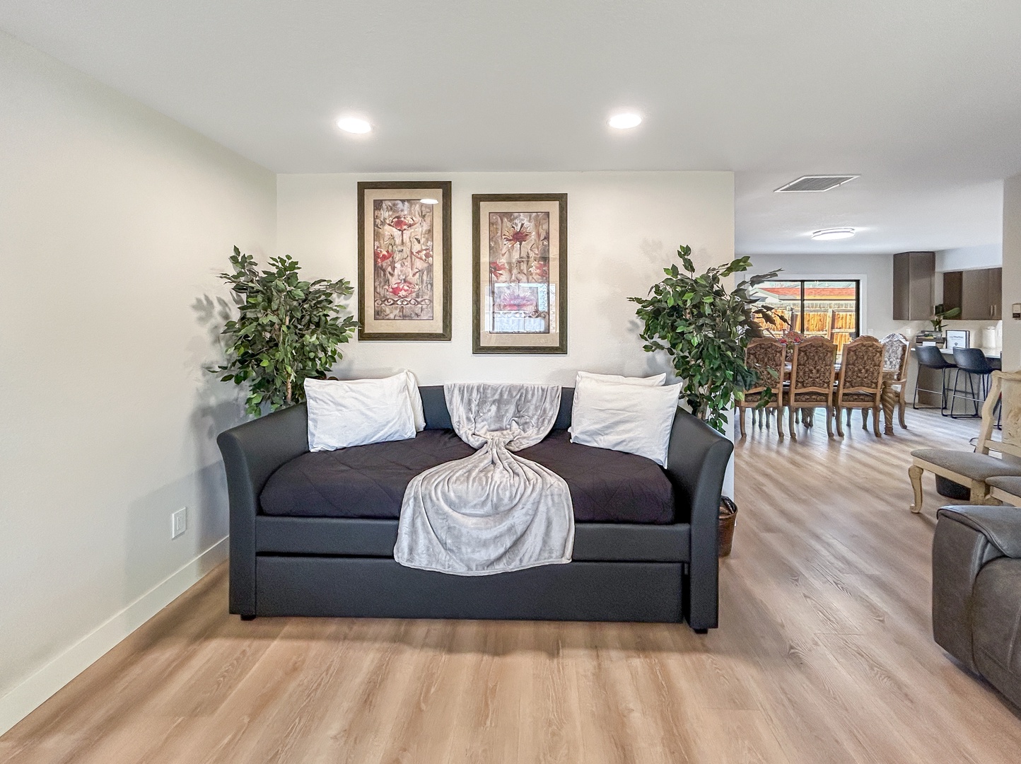 Unwind on your cozy trundle day bed with soft pillows in this bright, open living space.