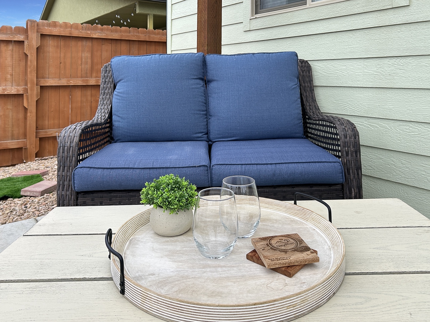 Unwind on your private patio with plush blue cushions and a coffee table ready for morning drinks or evening relaxation.