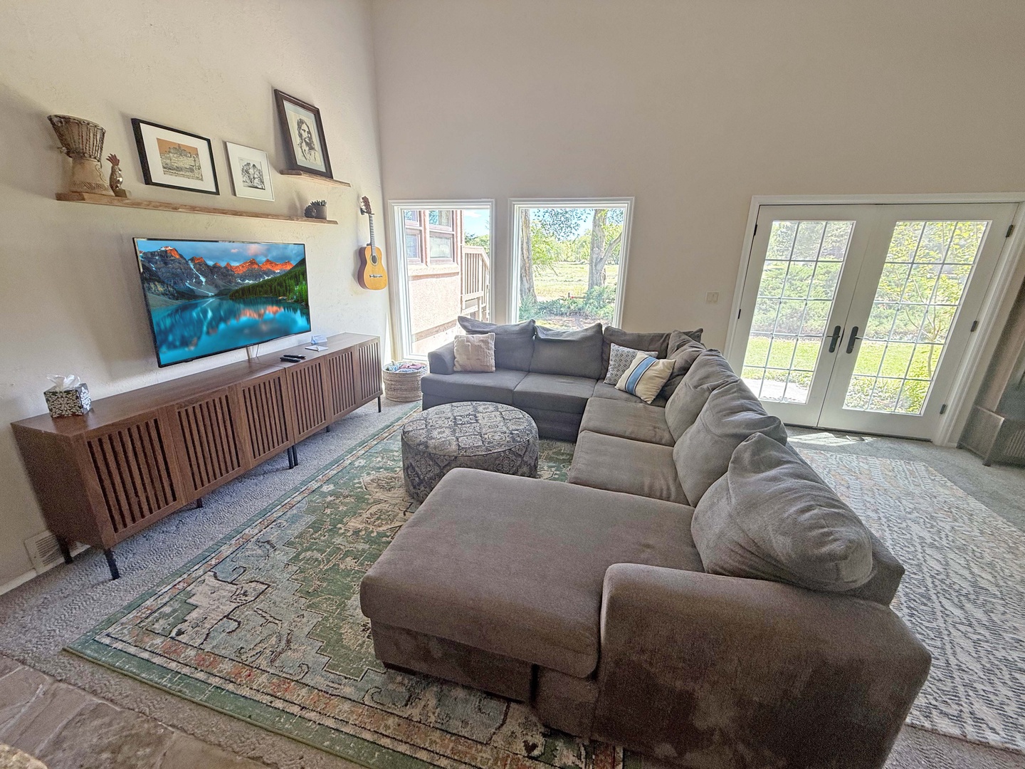 Sink into your plush sectional and relax beneath soaring vaulted ceilings in this sunlit living room.