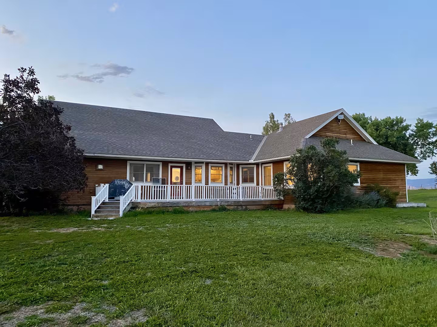 Spacious retreat with welcoming porch and lush lawn, set in a peaceful countryside location.