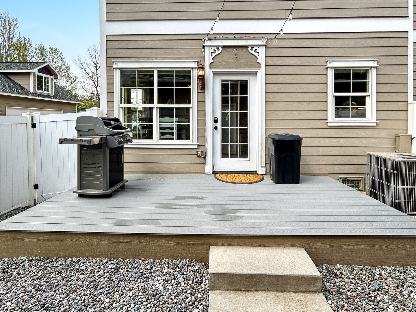 Small, fenced backyard with a gas grill. Perfect for your furry friend or storing bikes.