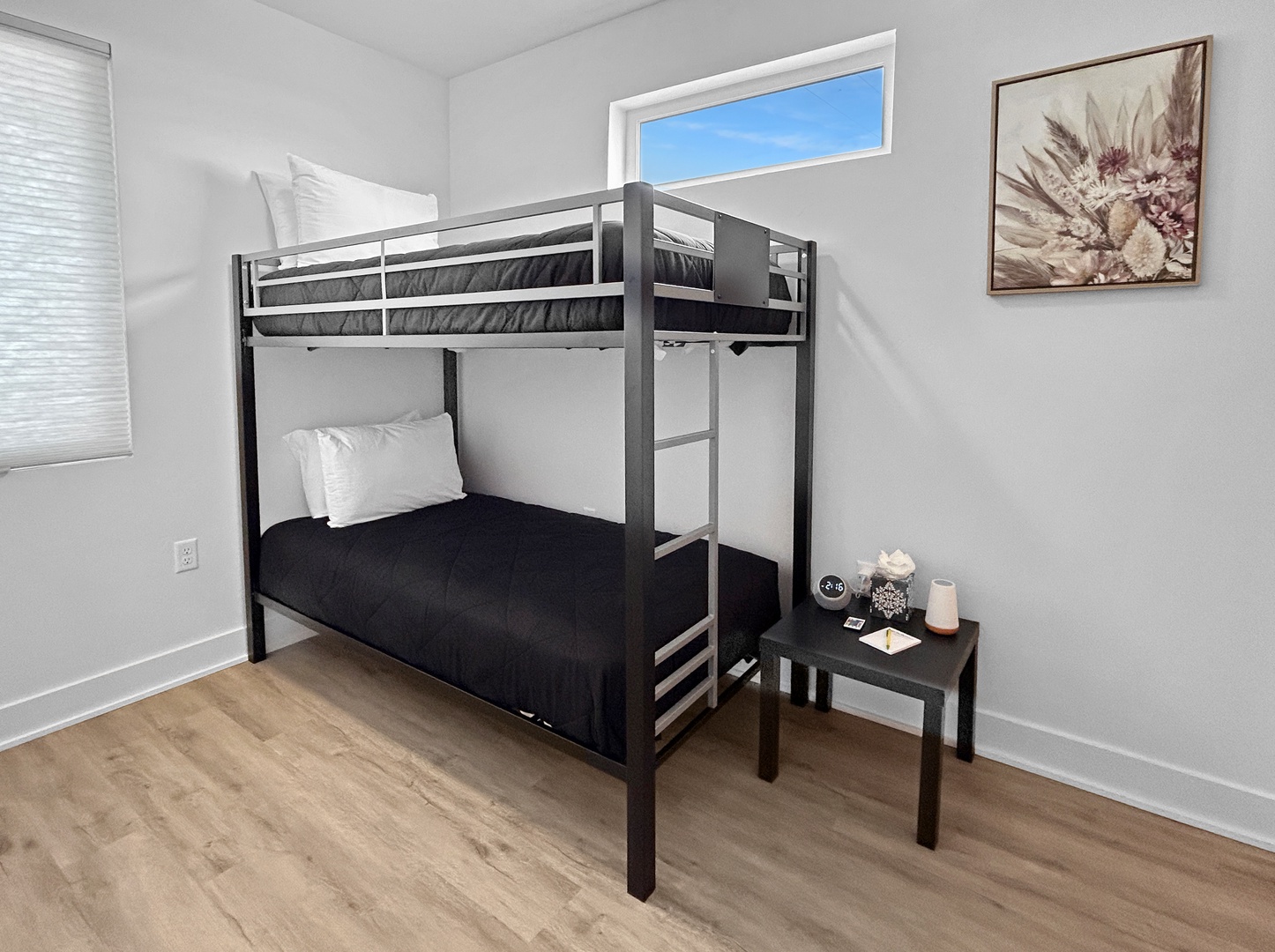 Cozy bunk bed setup with crisp linens and bedside conveniences for a restful night's sleep.