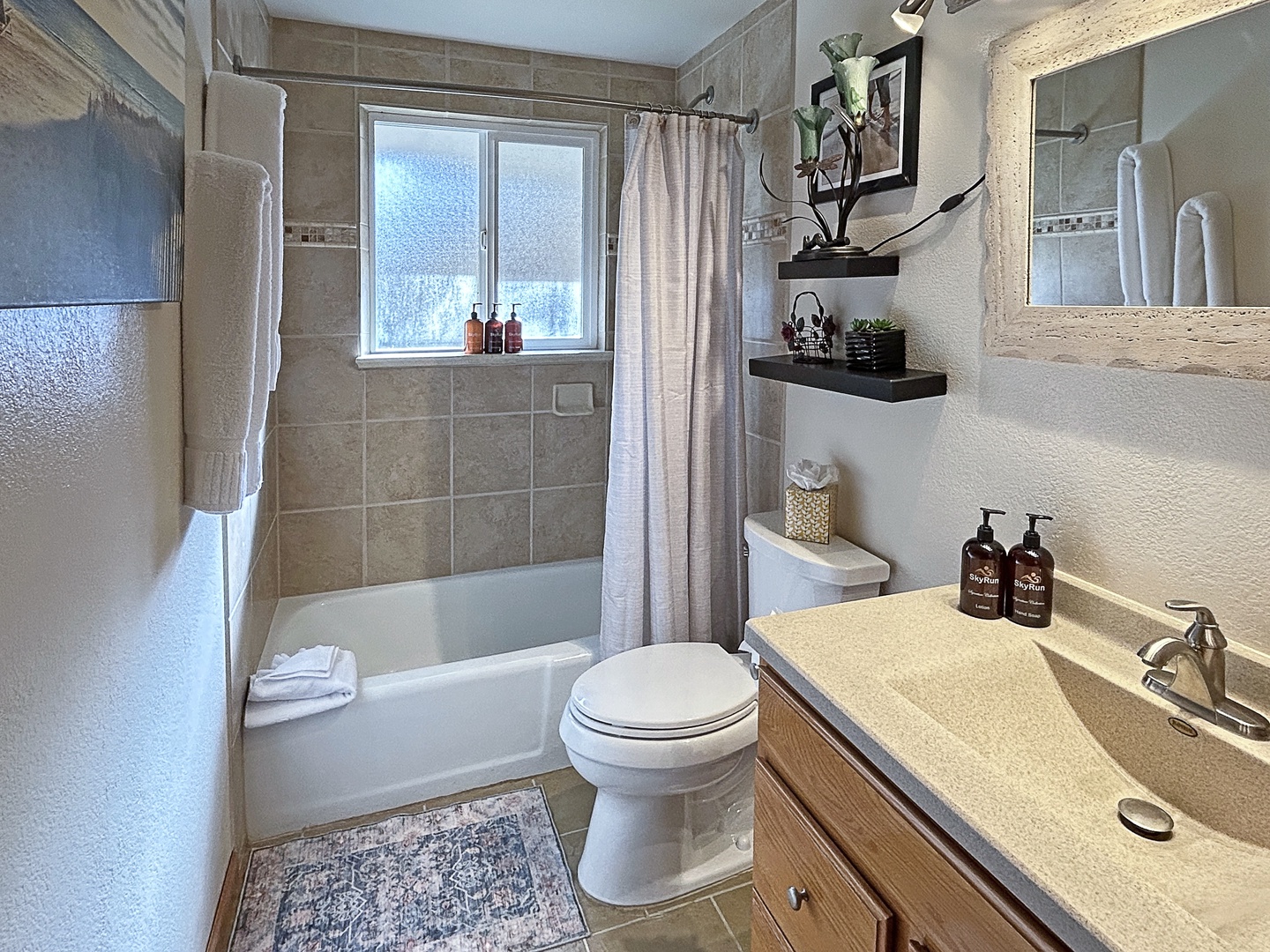Spa-like bathroom with warm stone tiles and elegant finishes.