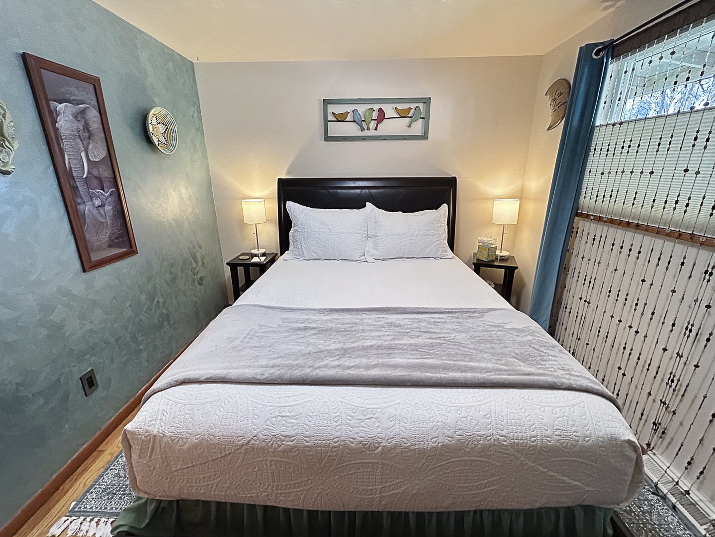 Plush bedroom with soft linens and warm, relaxing lighting.