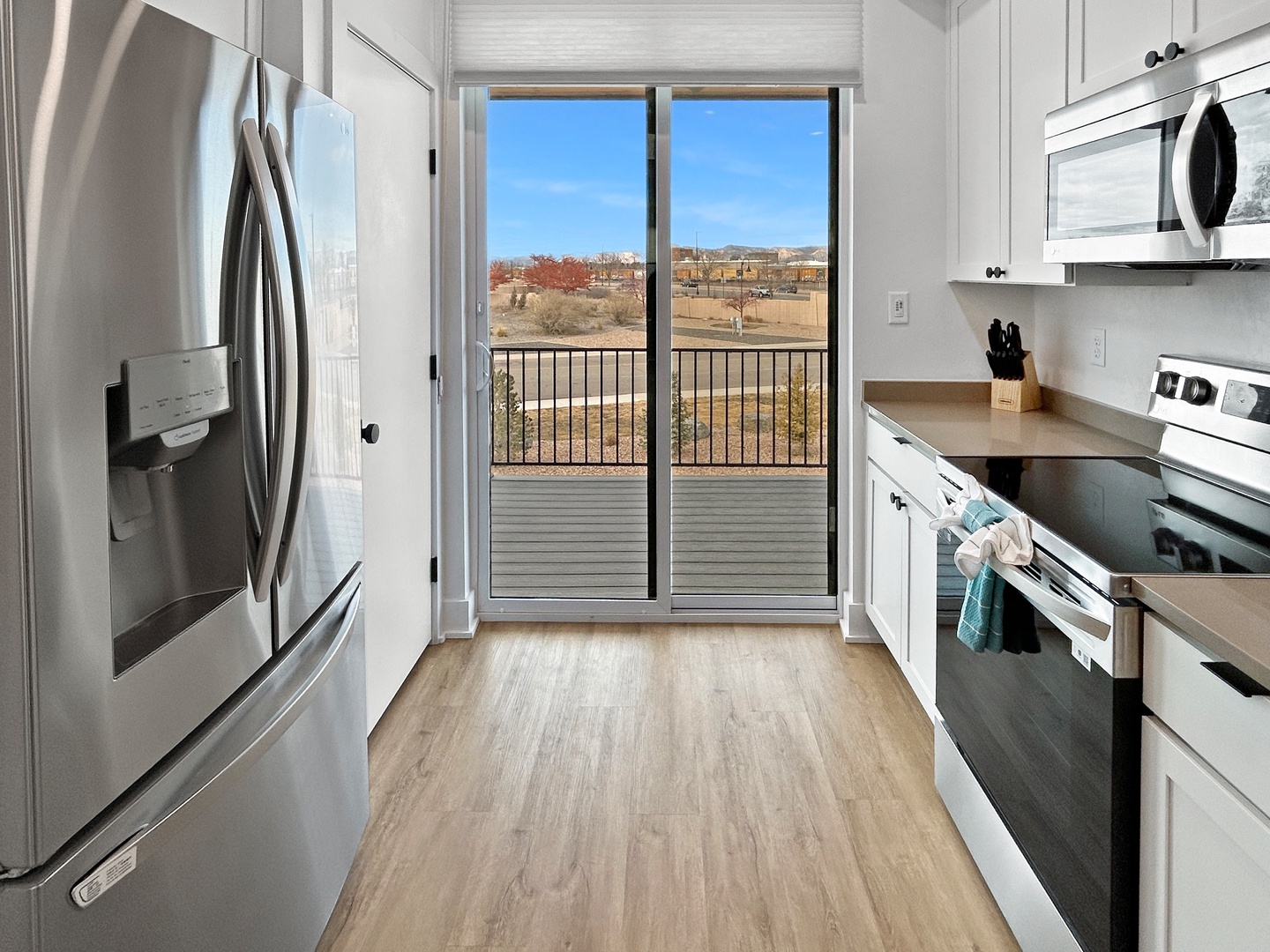 Your fully equipped kitchen opens to a private balcony with scenic views, perfect for morning coffee or sunset cooking.