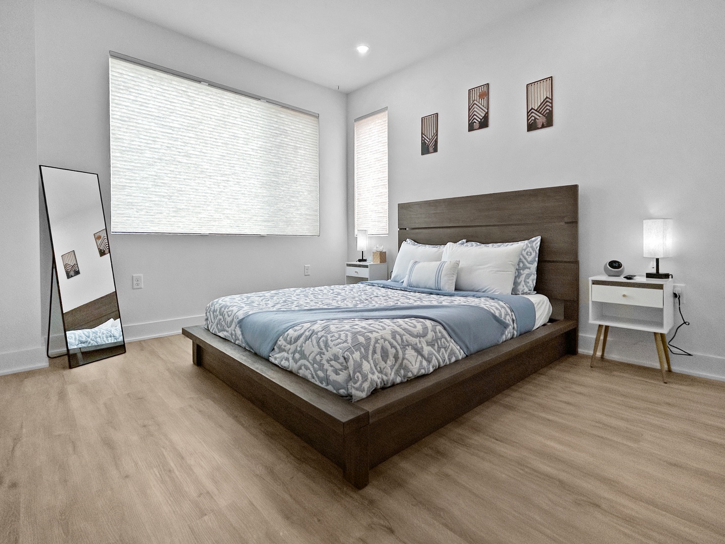 Drift into peaceful sleep in your serene bedroom, where soft blues and warm wood create the perfect retreat after busy travel days.