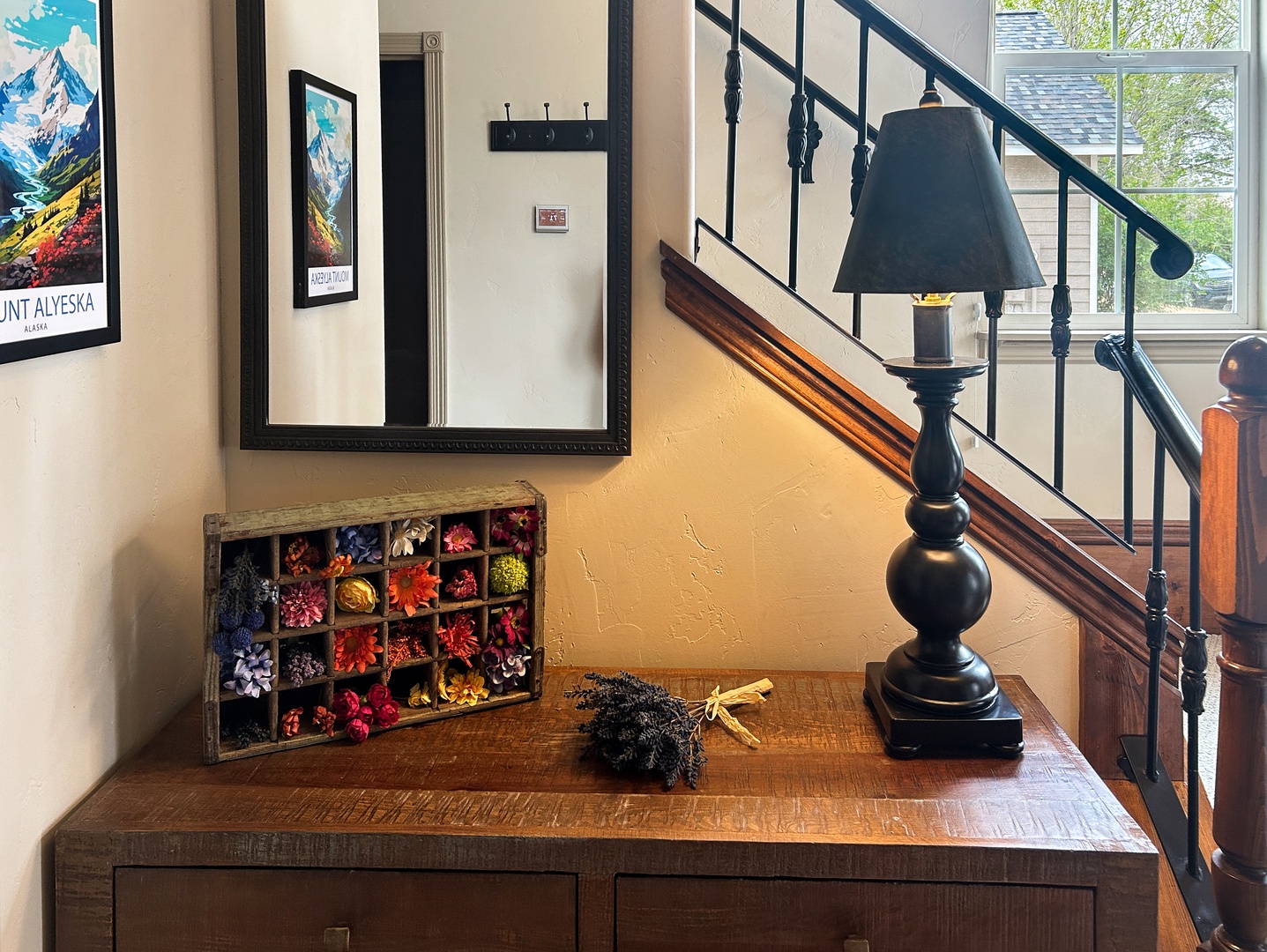 You'll love this charming entry with vintage décor, colorful flower display, and warm wooden details creating a welcoming home-away-from-home feeling.