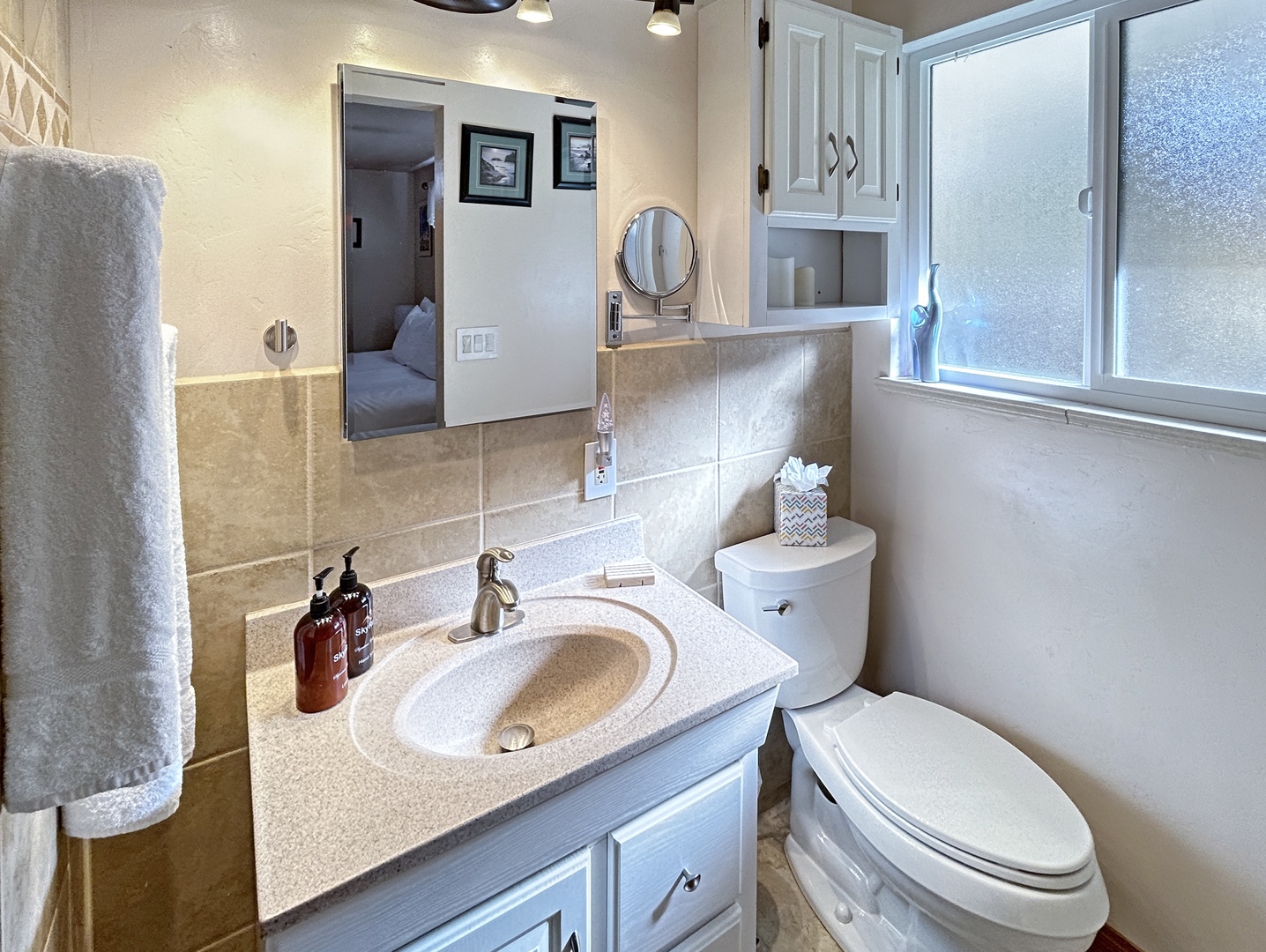 Bright private bath with quality amenities and soft towels.