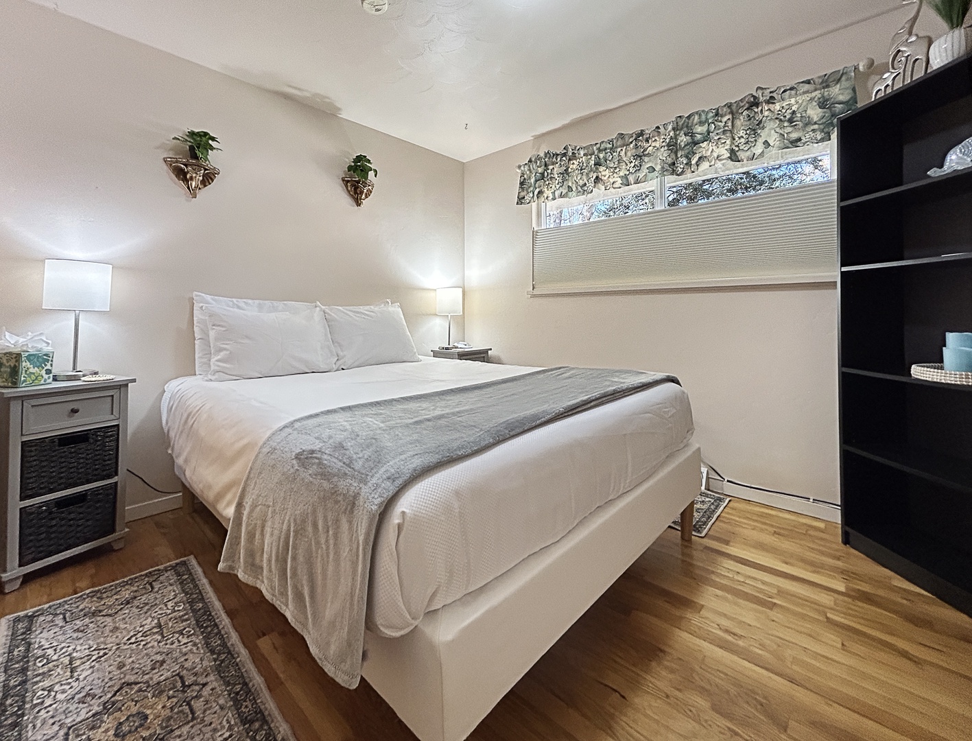 Serene bedroom with crisp linens and warm wood floors.