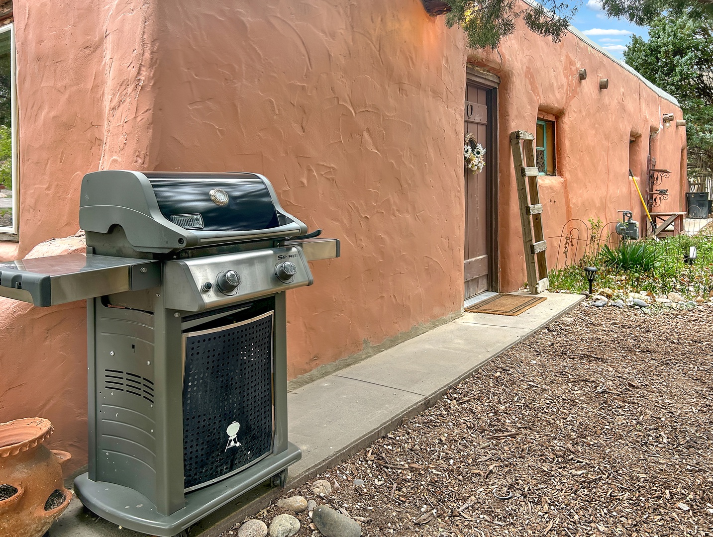 Fire up the grill and savor outdoor dining against this beautiful adobe backdrop.