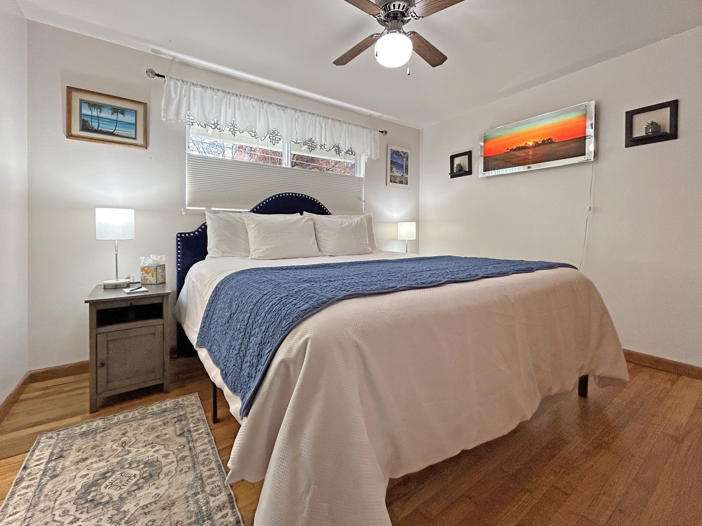 Cozy bedroom with soft linens, warm light, and morning sun.