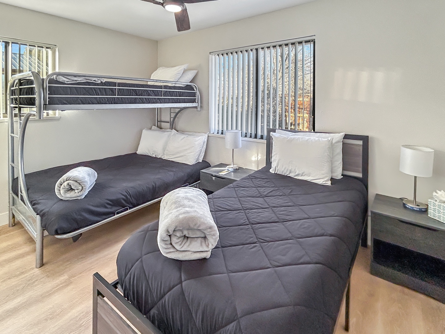 Rest comfortably in your thoughtfully arranged bedroom featuring a cozy bunk bed and single bed, all dressed in soft linens.