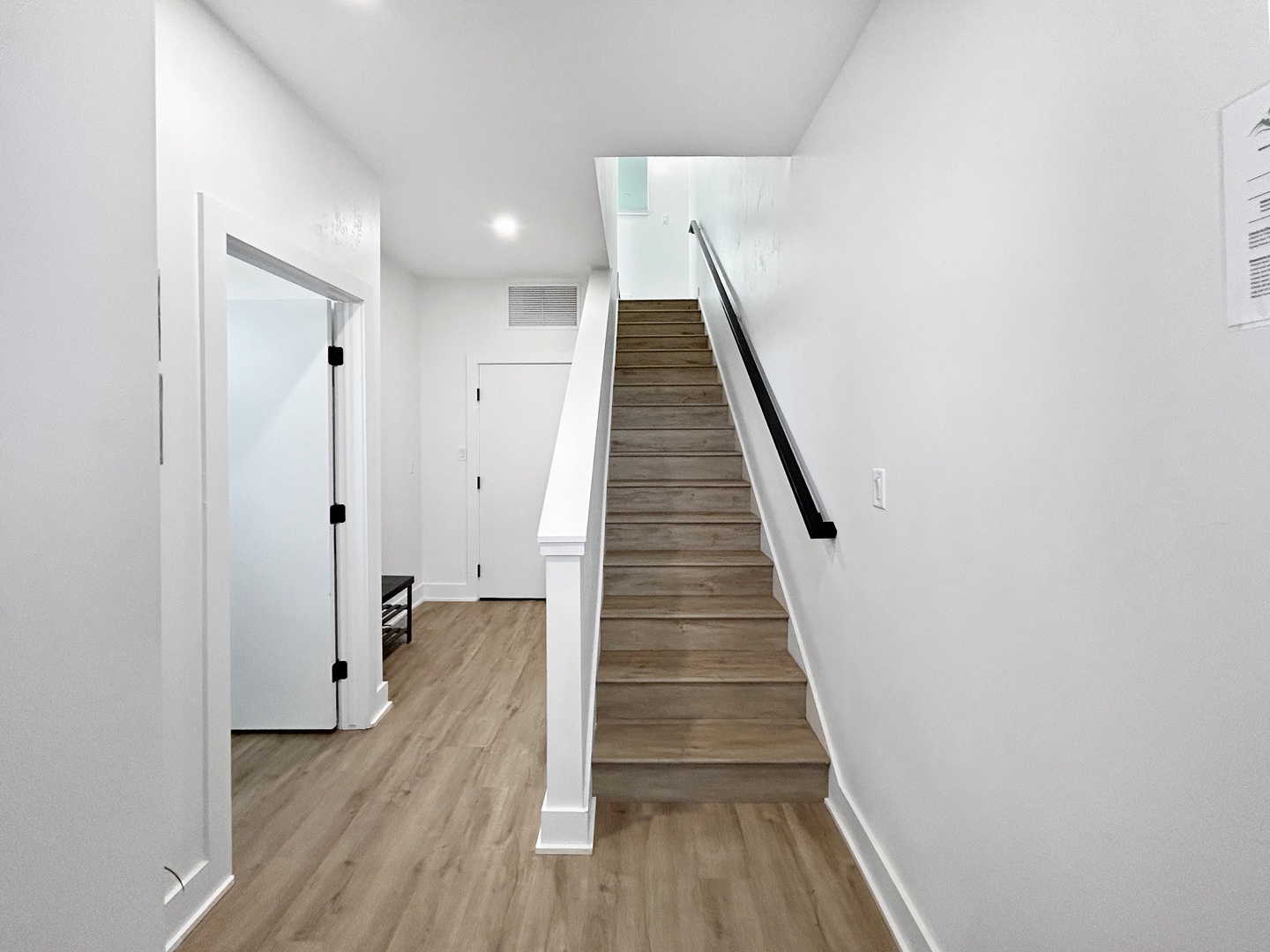 Stairs leading to main living area and door to attached garage.