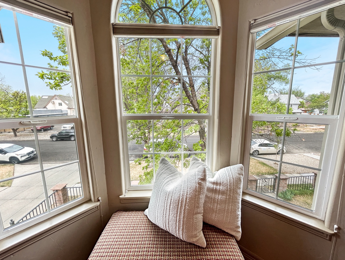 Curl up in your cozy window nook with soft pillows and watch the world go by through elegant arched windows.