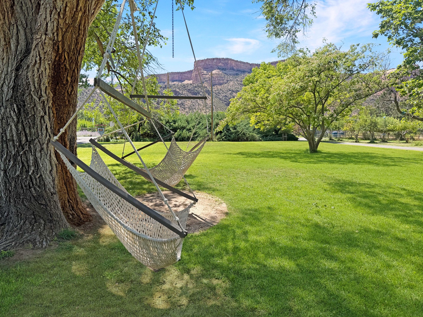Swing gently in your private hammock chairs beneath shade trees, surrounded by lush lawns and stunning desert vistas.