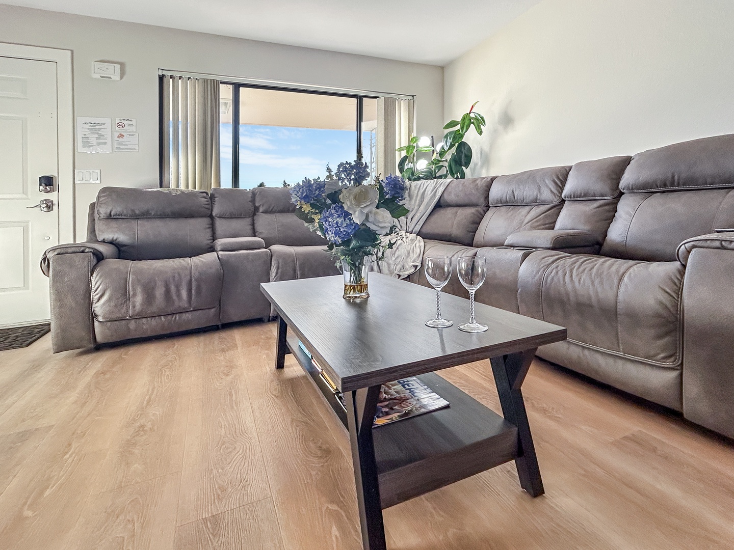 Sink into this plush sectional sofa where comfort meets elegance, with wine glasses ready for your evening unwind.