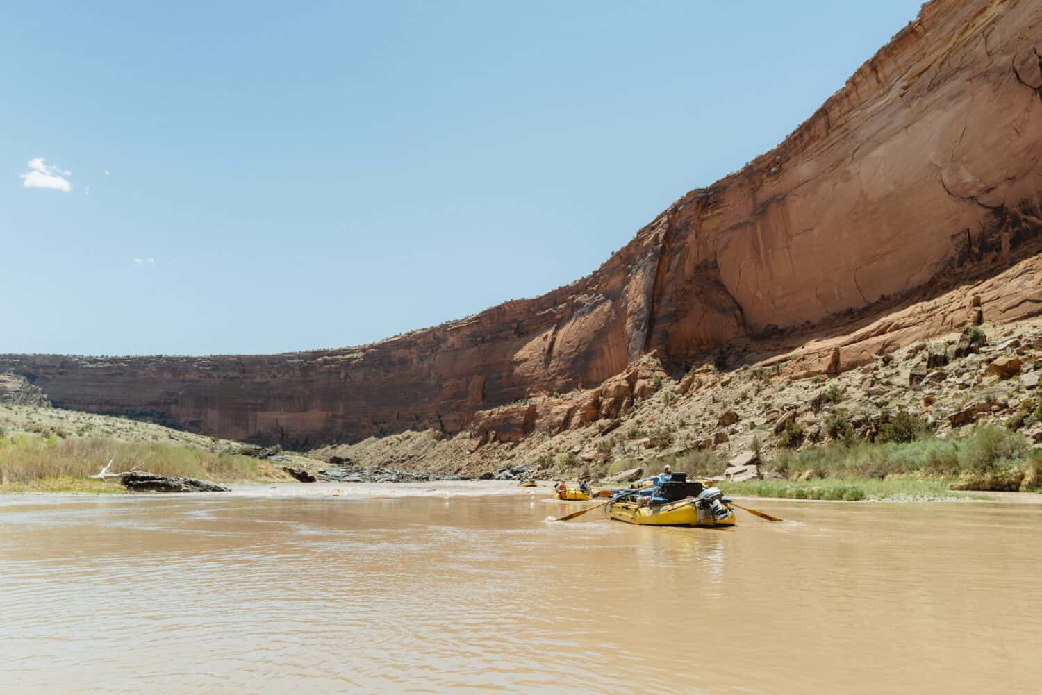 River rafting adventure through dramatic canyon landscape with towering rock formations and scenic wilderness.