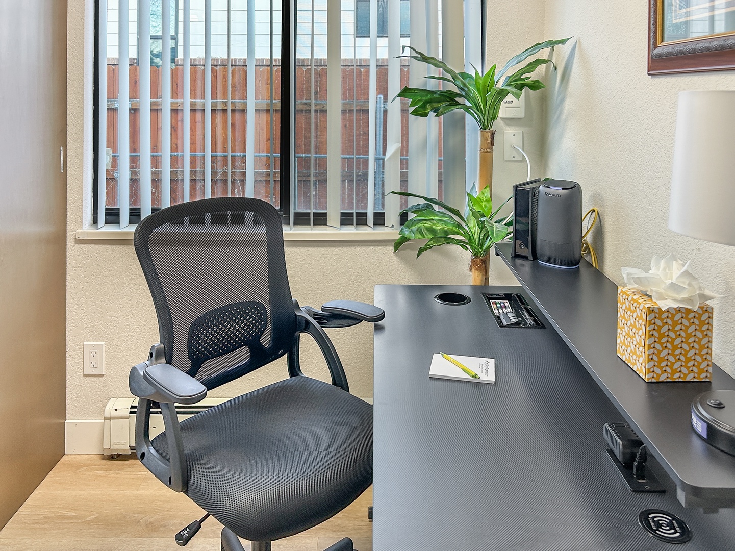 Your dedicated workspace features an ergonomic chair and spacious desk, perfect for productive remote work sessions with natural light streaming in.