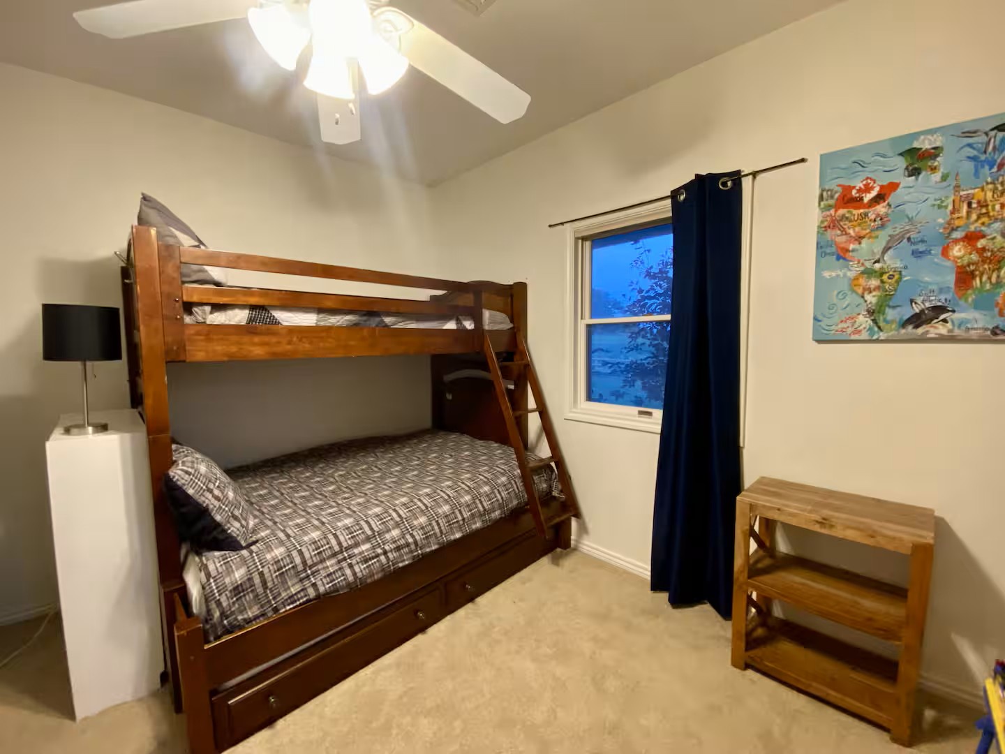 Your kids will love this cozy bedroom with sturdy double/twin bunk beds and playful world map decor.