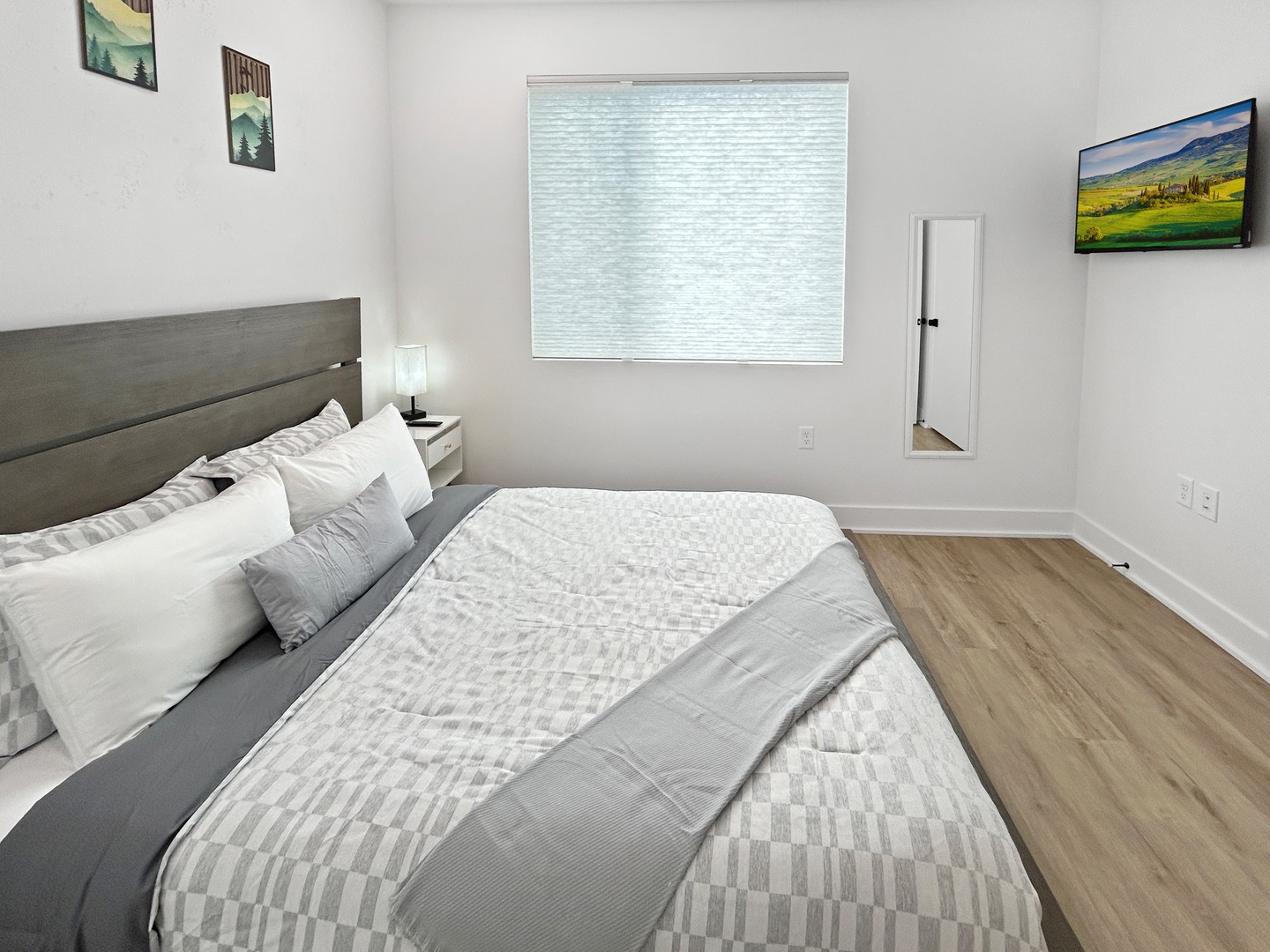 Sink into crisp linens and modern comfort in your peaceful bedroom retreat, complete with beautiful artwork and natural light.