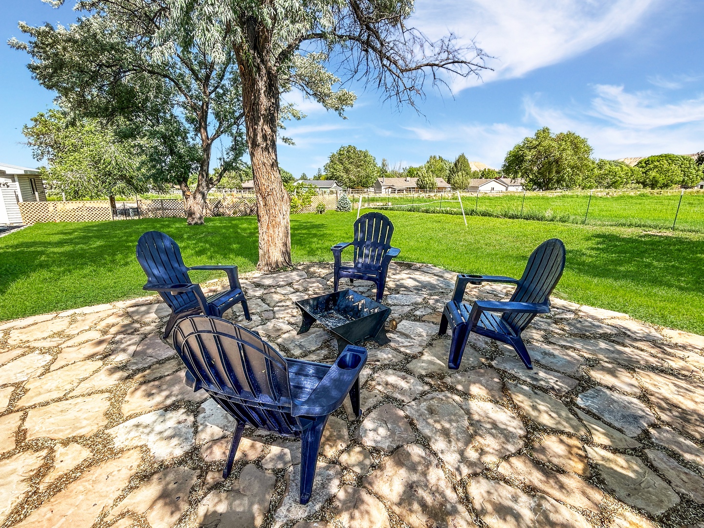 Unwind around the fire pit in your private, tree-shaded backyard with comfy Adirondack chairs.