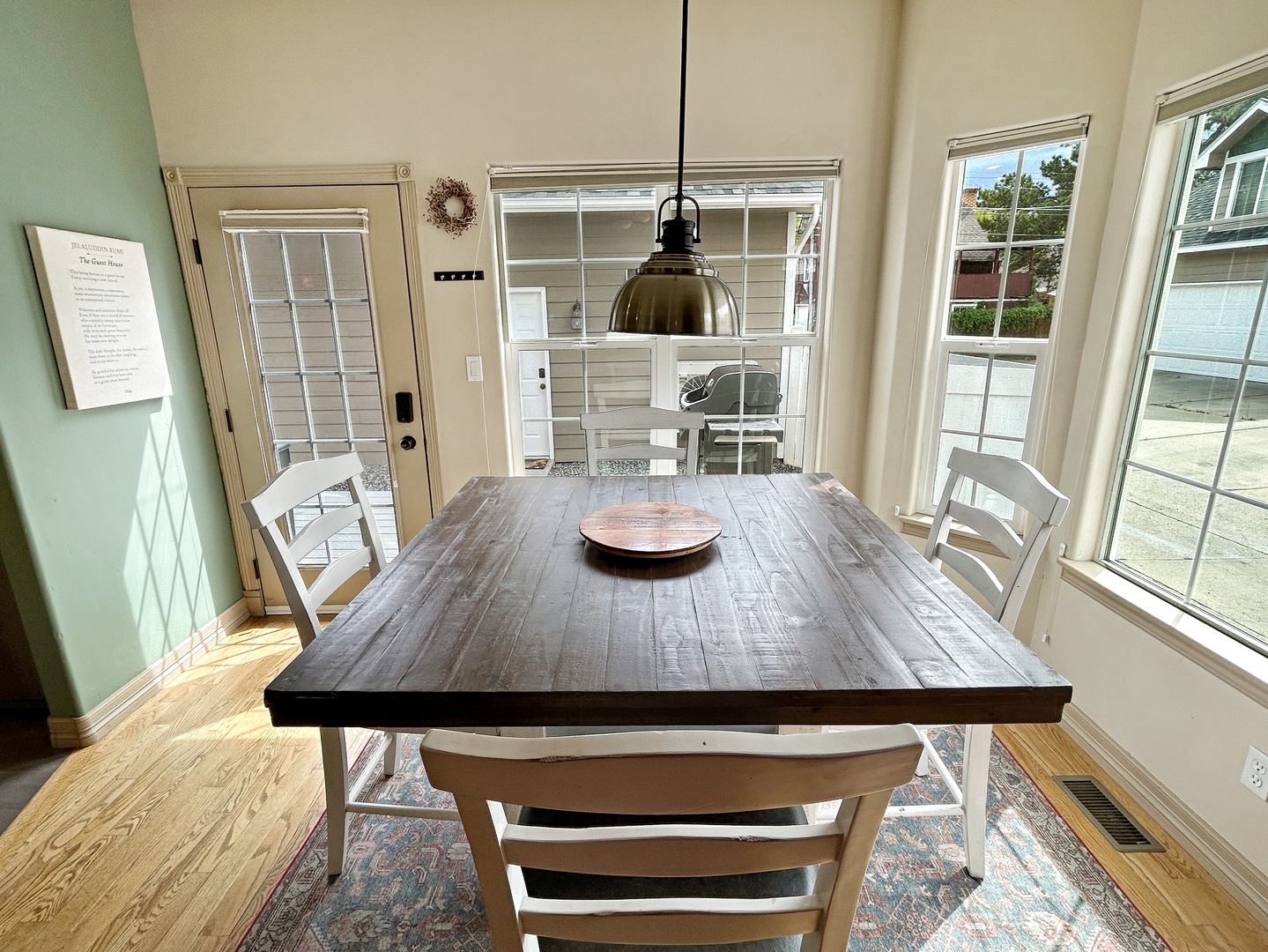 Gather around your rustic dining table where natural light streams through large windows, creating the perfect spot for shared meals and morning coffee.