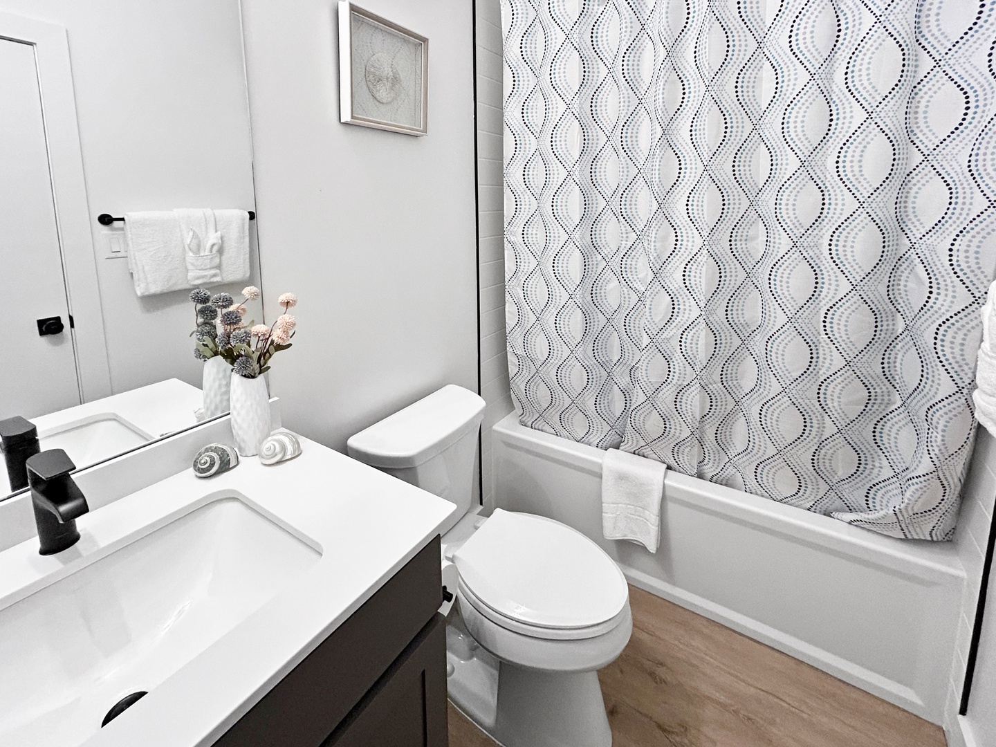 Freshen up in your stylish bathroom featuring a relaxing tub-shower combo.