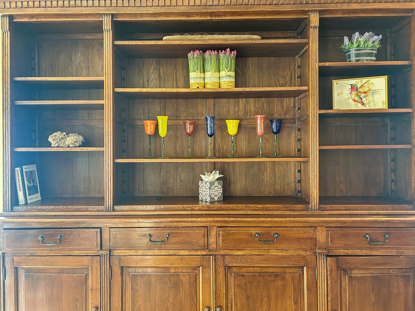 Admire the elegant built-in shelving displaying colorful glassware and charming decorative touches throughout your stay.
