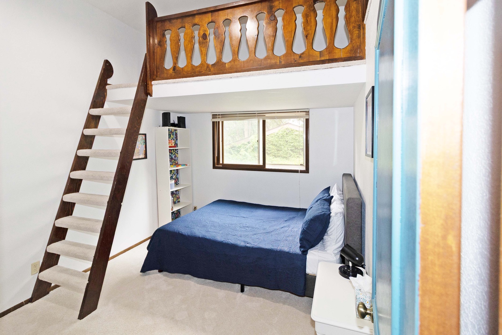 Your cozy retreat features a comfortable bed under a charming wooden loft.