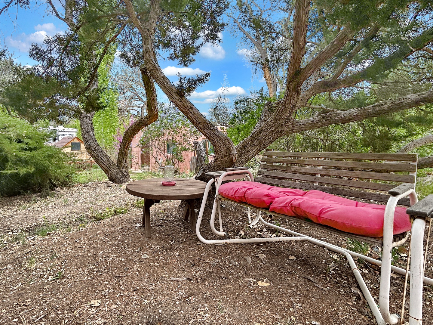 Unwind on your private bench beneath sprawling shade trees, where afternoon coffee and quiet moments feel perfectly natural.