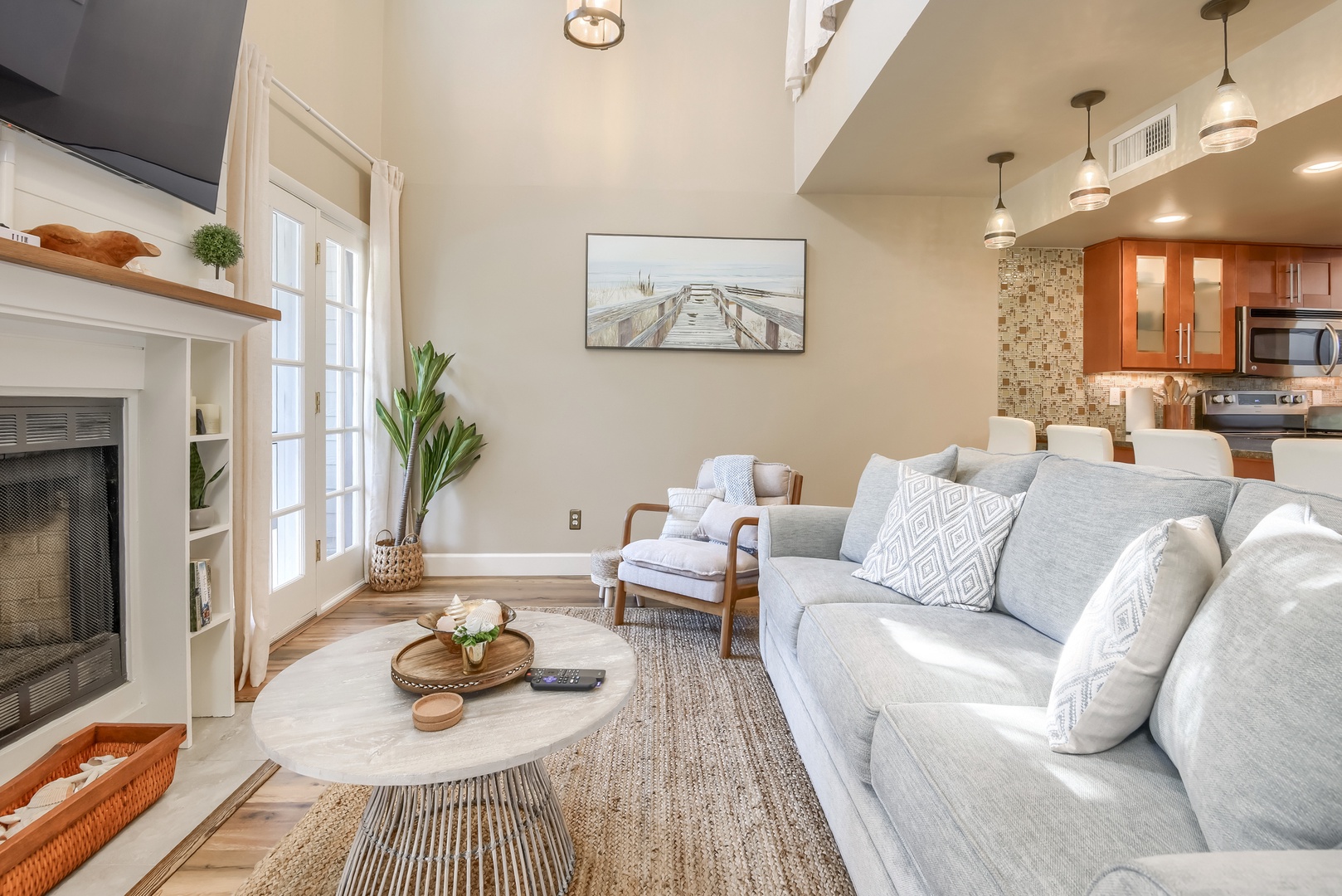 Cozy sofa and reading chair with an open view into the kitchen