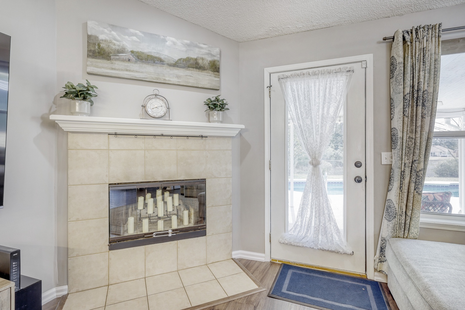 Elegant tiled fireplace with decorative candles.