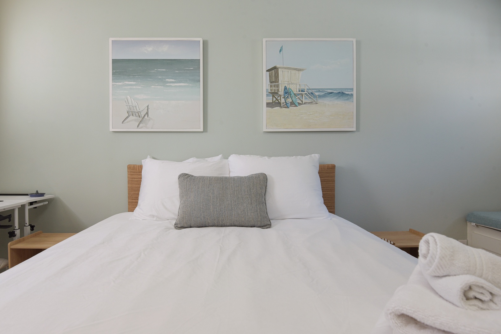 Crisp white linens and beach-inspired art for a restful night