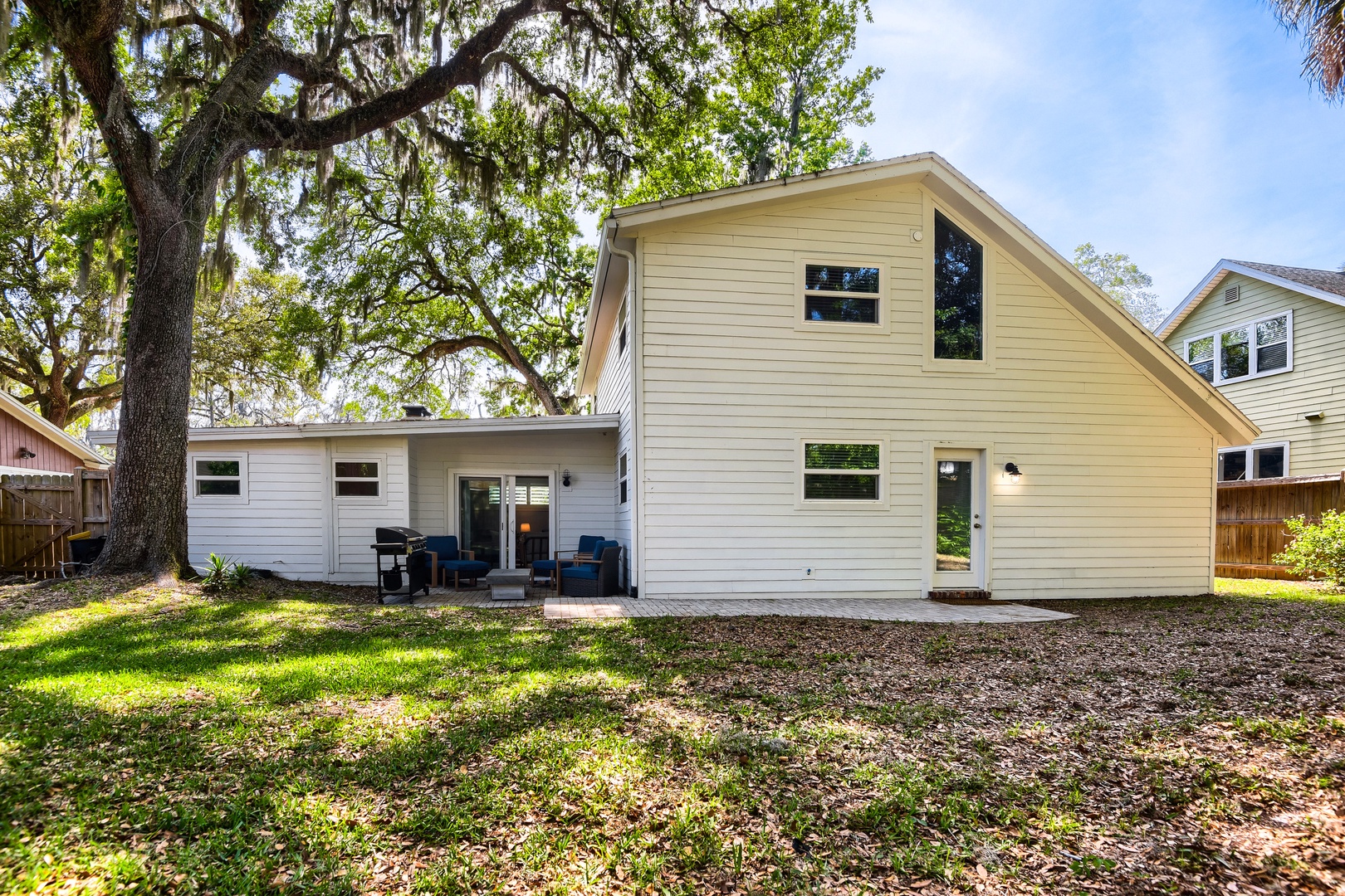 Nestled under majestic oak trees with Spanish moss