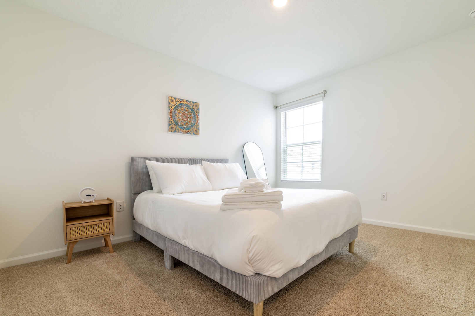 Sink into your plush bed where crisp linens and soft towels await. Wake to natural light streaming through the window—your peaceful retreat is ready.