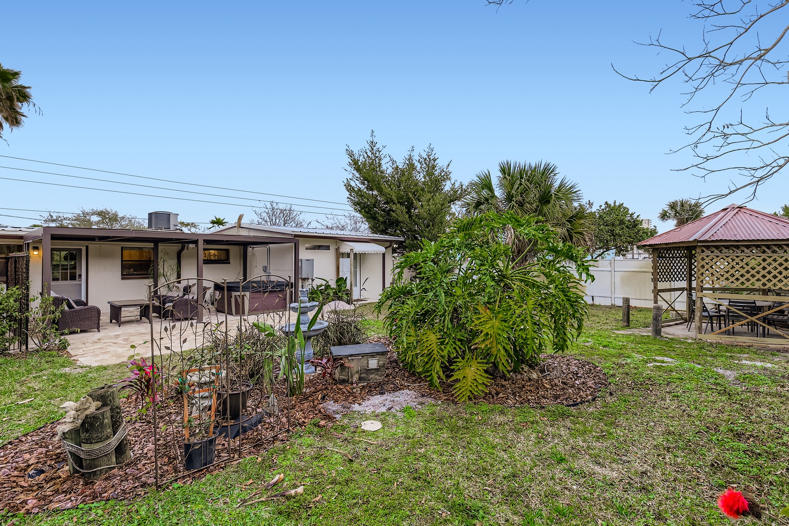Spacious backyard with tropical landscaping.