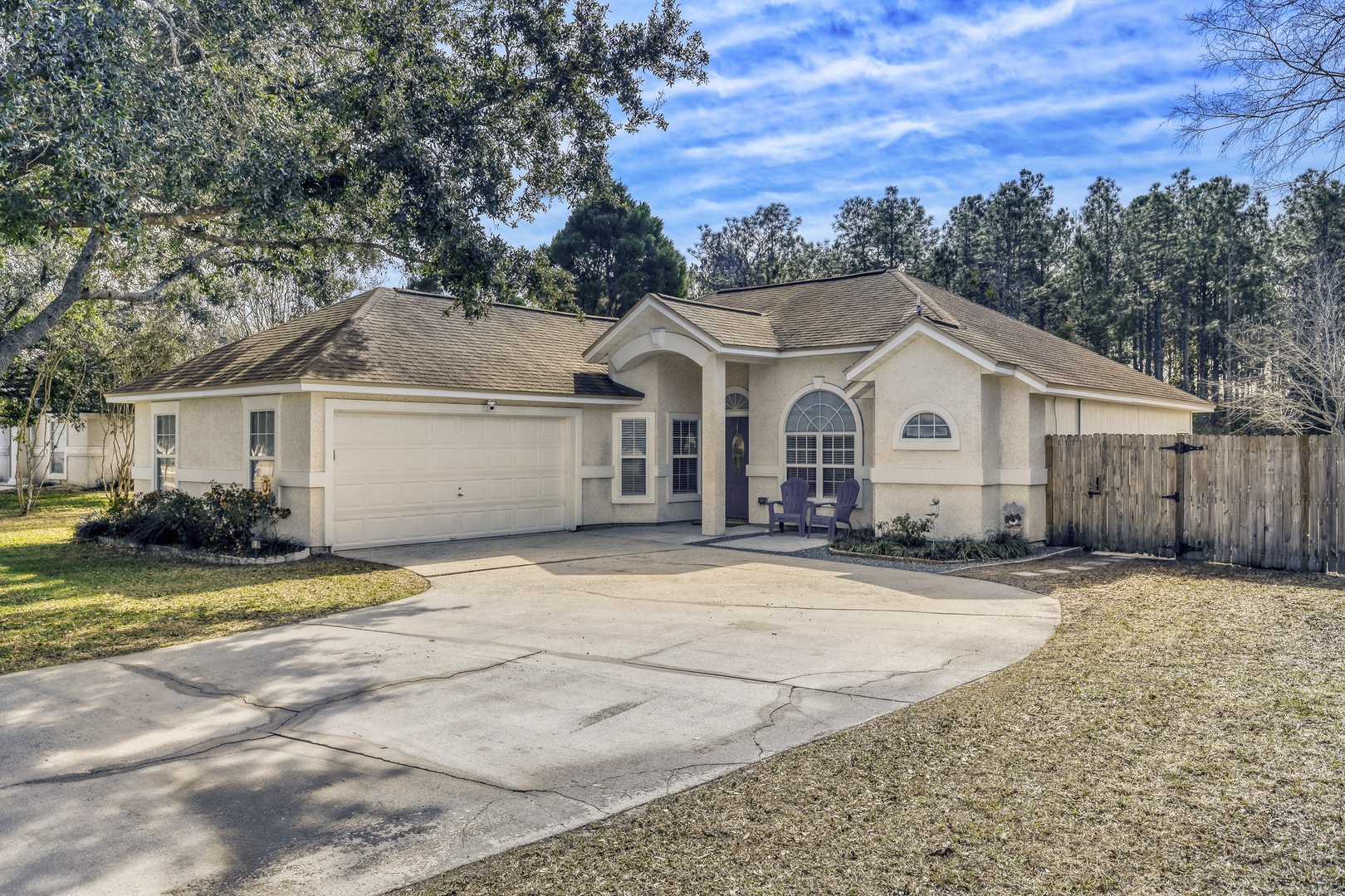 Beautiful curb appeal with mature oaks