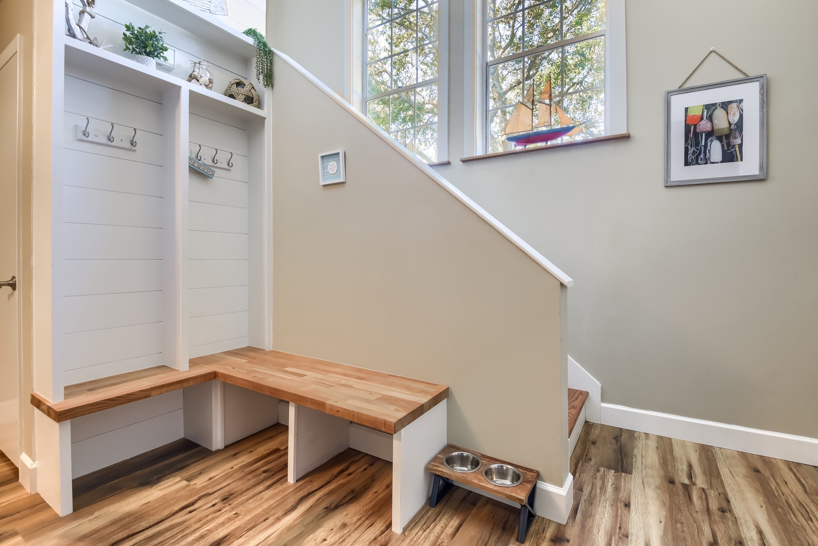 Welcoming entry with built-in bench, coat hooks and coastal touches
