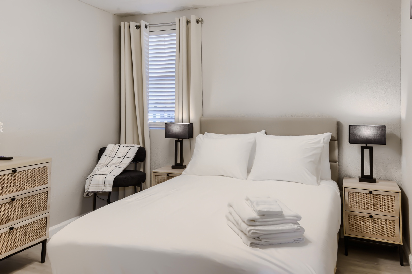 Second bedroom with queen bed and rattan nightstands
