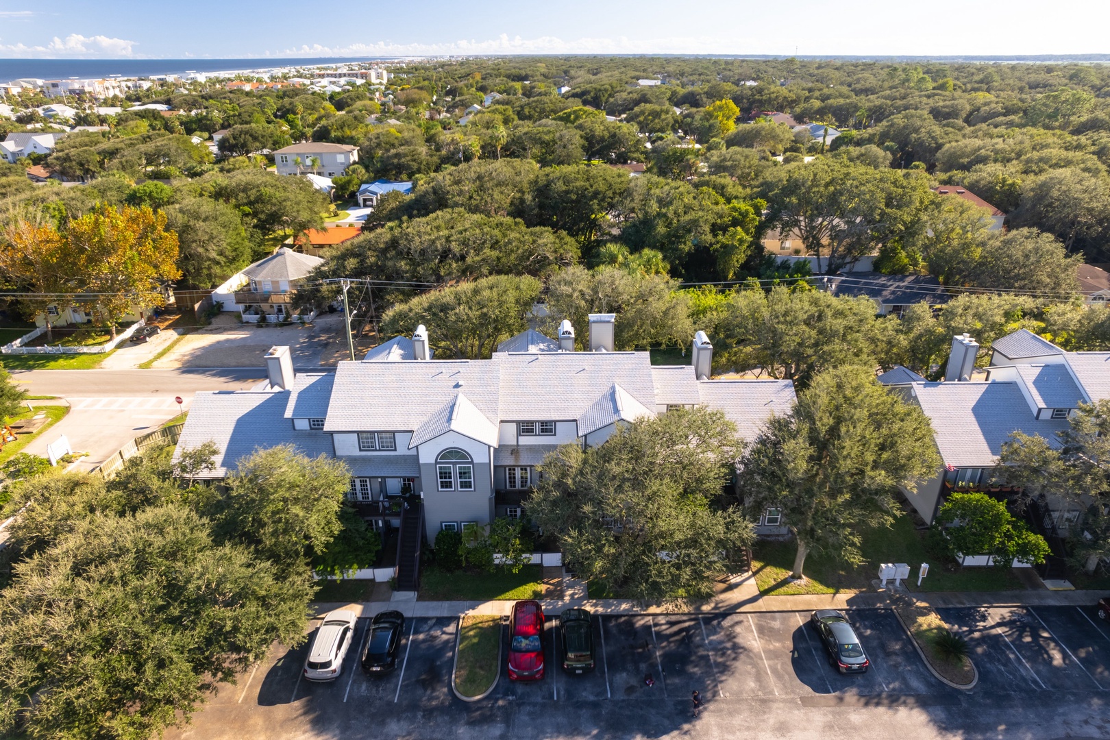 Townhome tucked into a leafy neighborhood with the ocean on the horizon