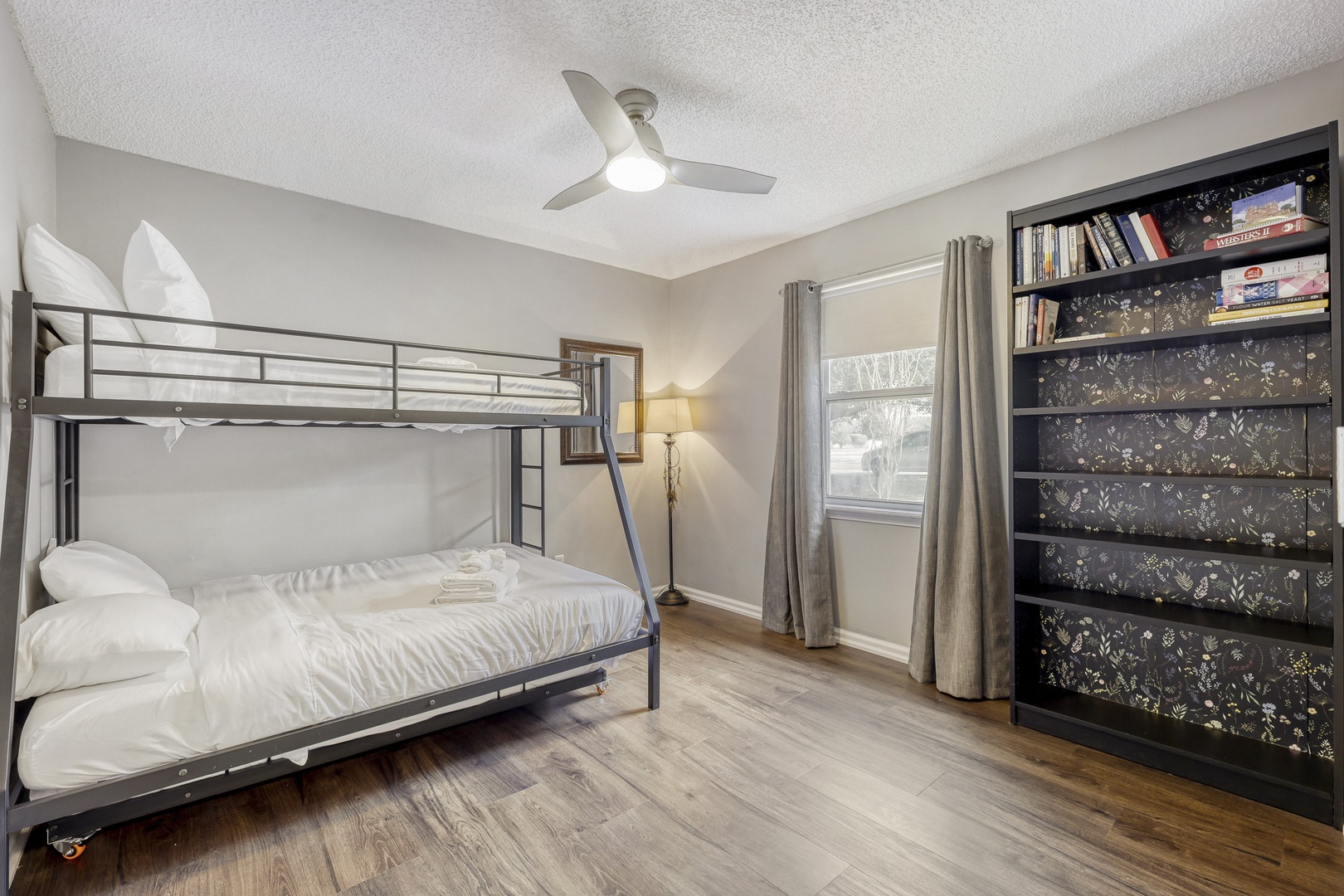 Family-friendly bunk room full bookshelf