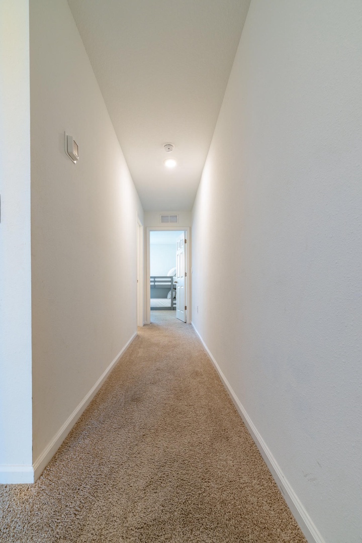 A bright hallway leads to comfortable living spaces, inviting you to explore your home away from home.