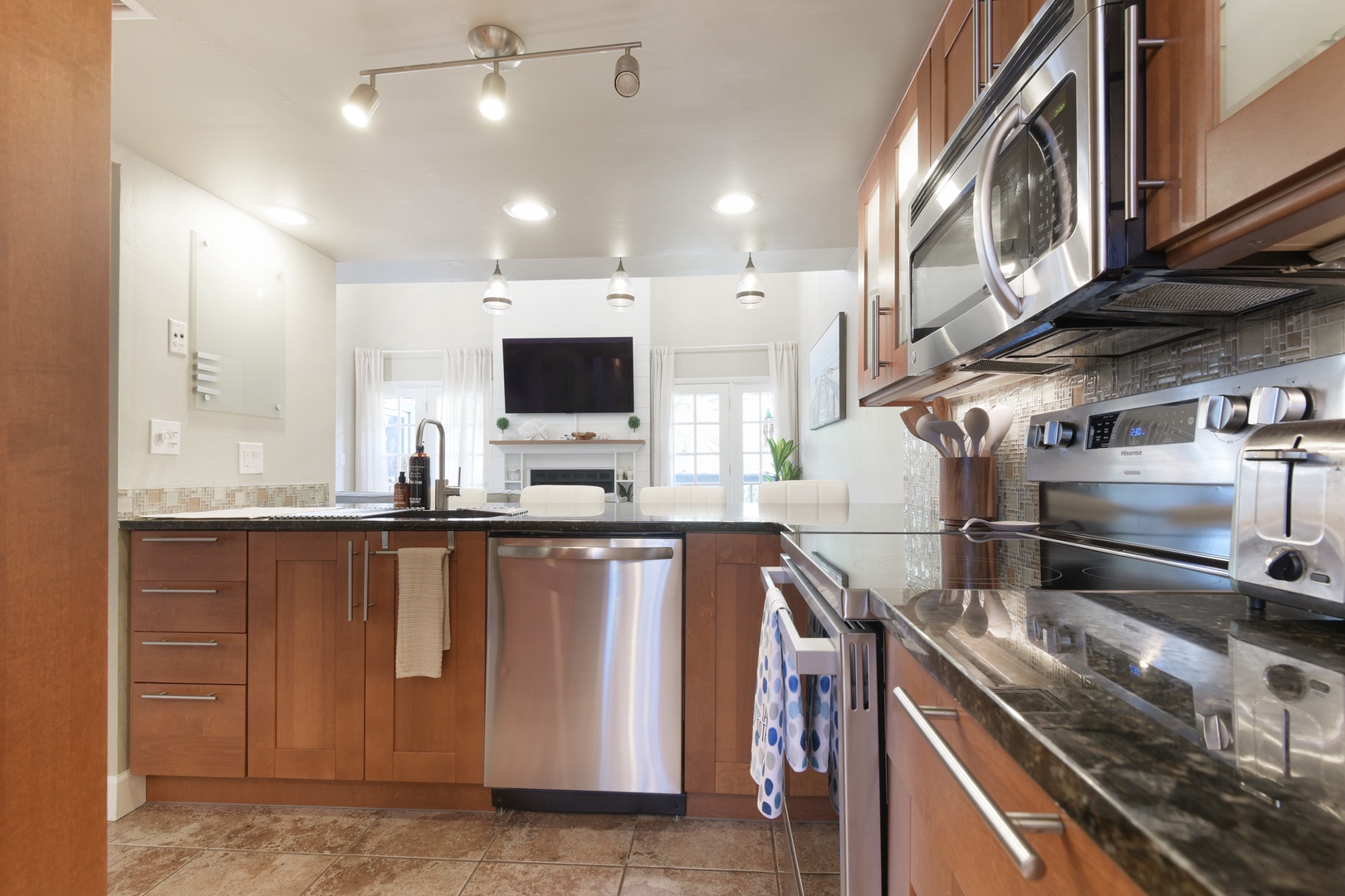 Galley kitchen with dishwasher, range, microwave and toaster